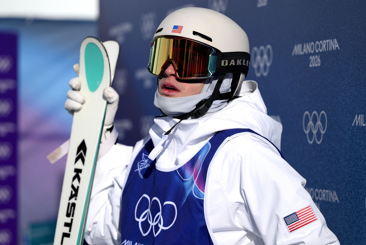 Charlie Mickel representing Team USA at the 2026 Winter Olympics in Milan Cortina, wearing his competition bib and holding his skis.